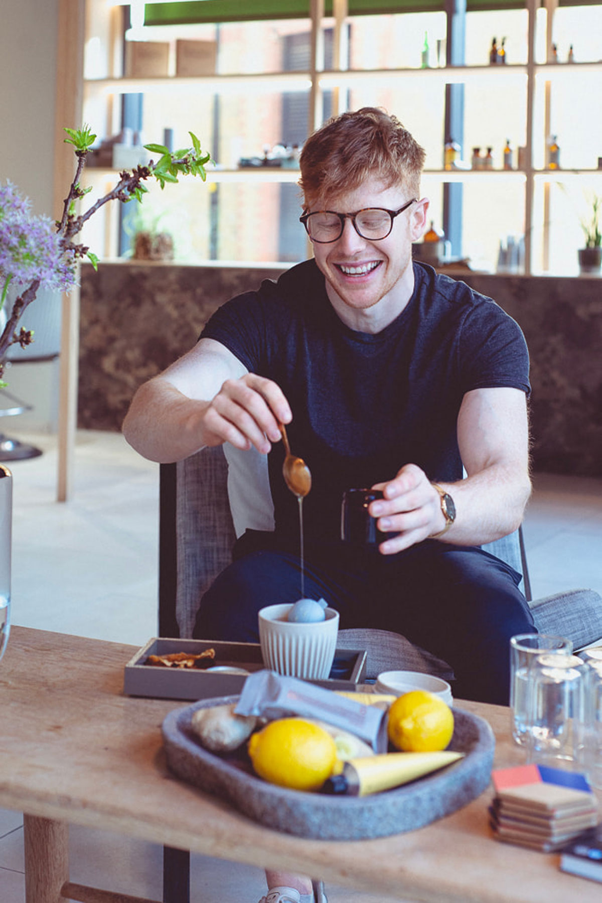 The coach is making a tea, smiling.